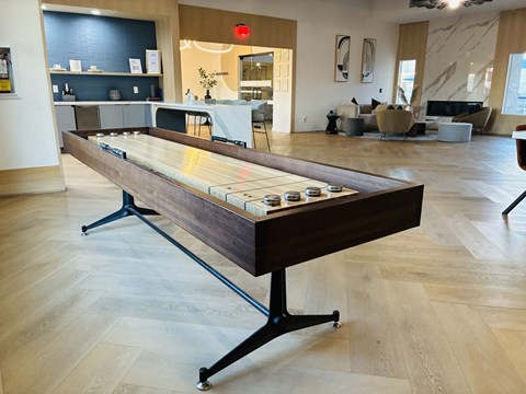 A shiny pool table in the middle of a room.