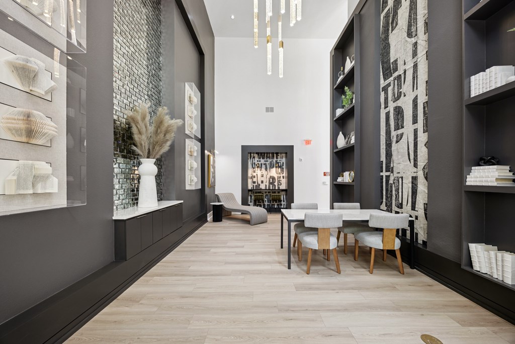 A modern interior with a long table and chairs.