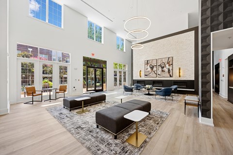 A modern living room with a large rug and a fireplace.