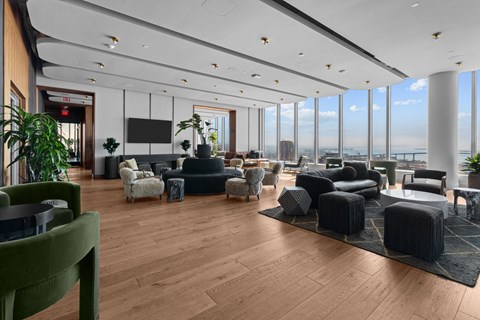 A modern living room with a green chair in the foreground.
