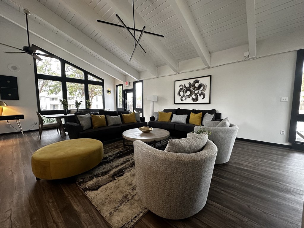 a living room with couches and chairs and a rug