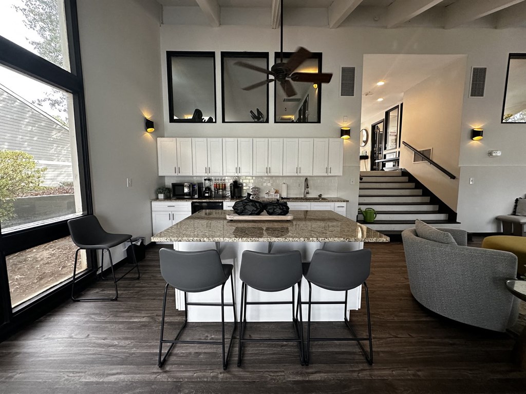 a kitchen and dining room with a marble table and chairs