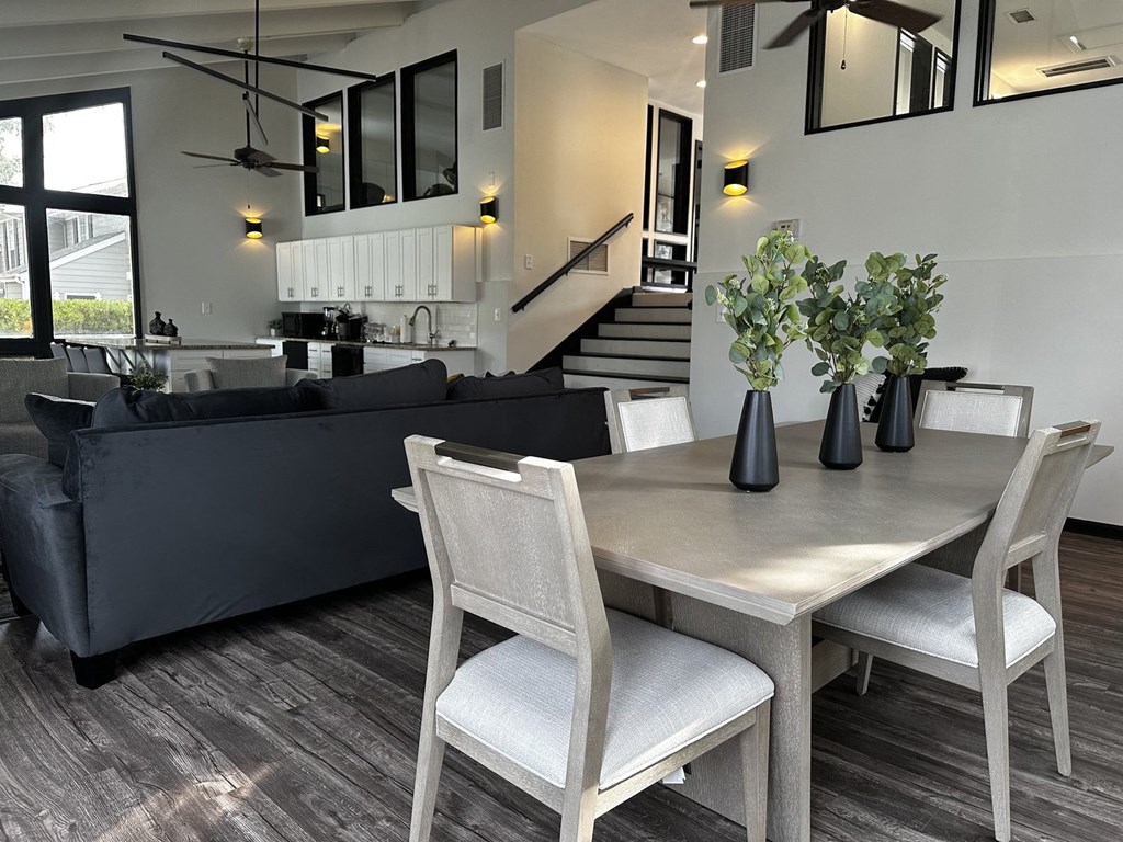 a dining room and living room with a table and chairs