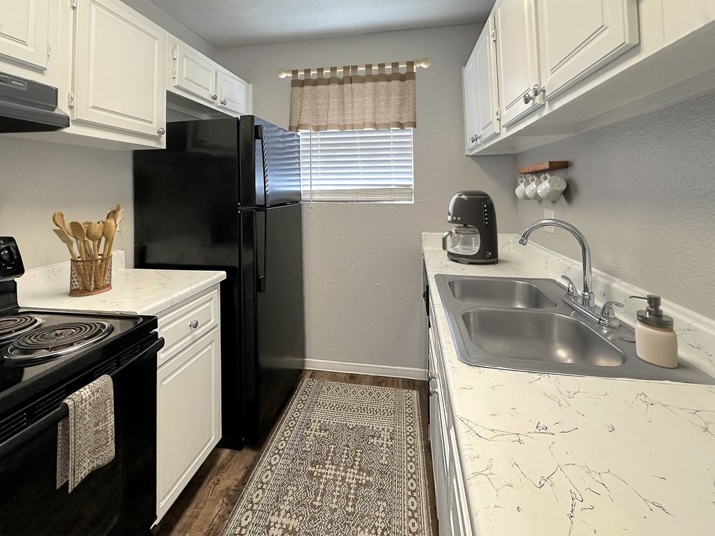 a kitchen with a sink and a refrigerator