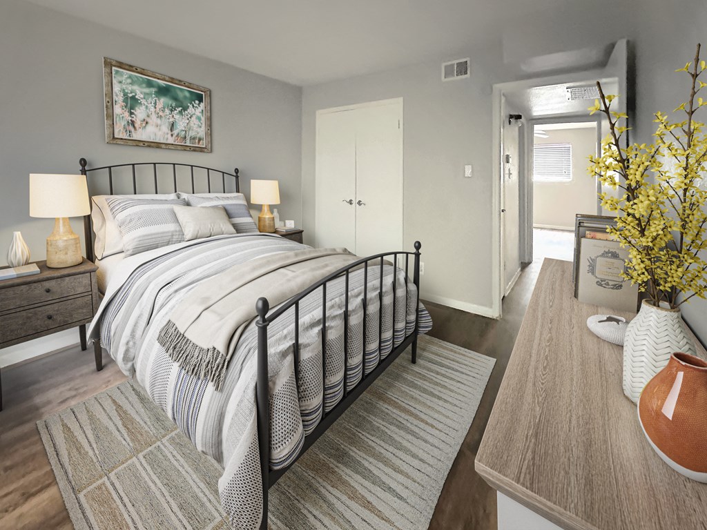 a bedroom with a bed and a door to a bathroom