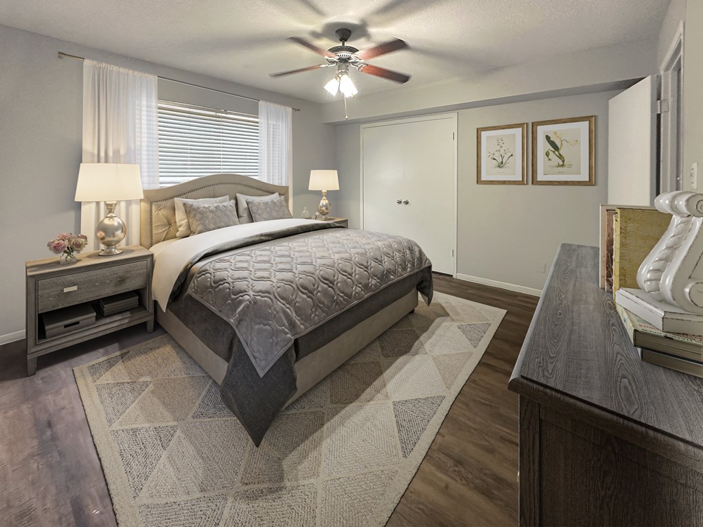 a bedroom with a bed and a ceiling fan