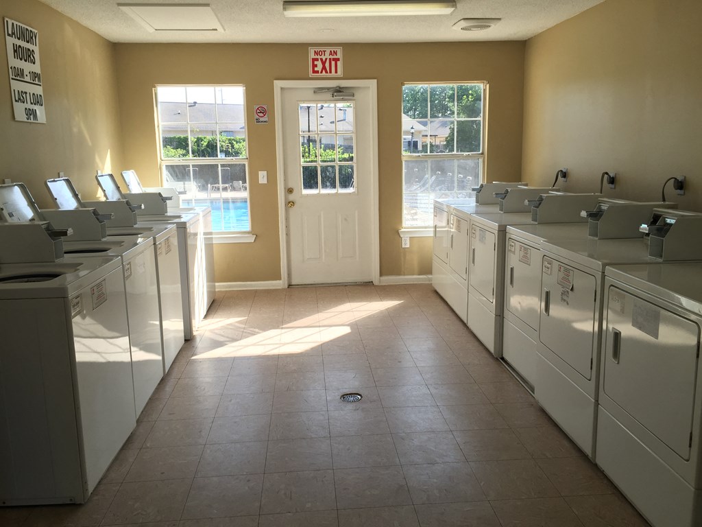 the laundry room is full of washers and dryers