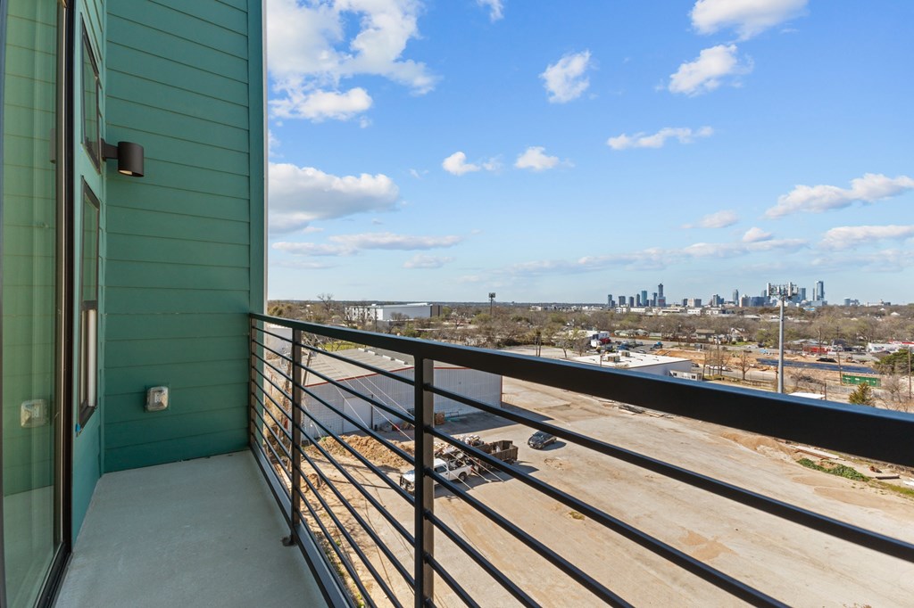 A balcony with a view of a city skyline.