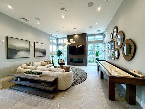 A modern living room with a large sectional sofa and a coffee table.