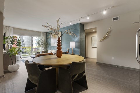 A modern dining room with a round table and chairs.