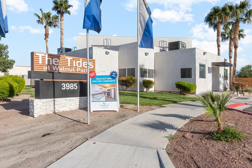 a white building with a sign that reads the tides of walnut park