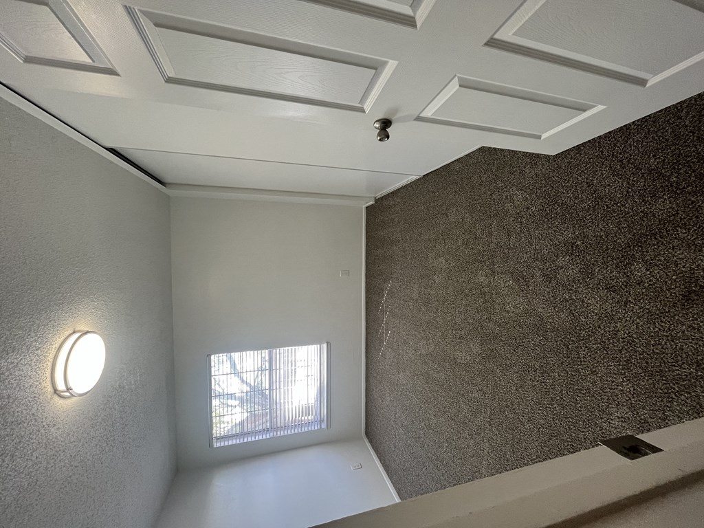 a small room with a window and a white ceiling
