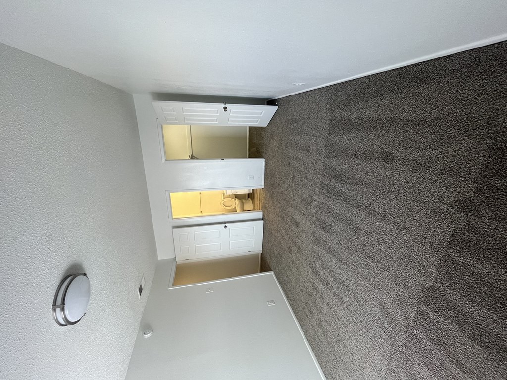 the view of a kitchen from the top of the stairs