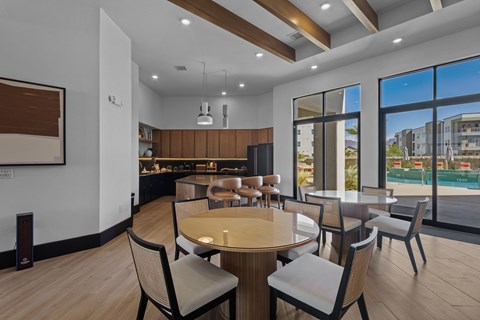 A modern dining room with a large table and chairs.