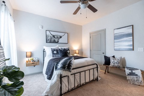 a bedroom with a bed and a ceiling fan