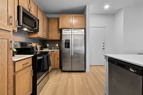 A kitchen with wooden cabinets and stainless steel appliances.