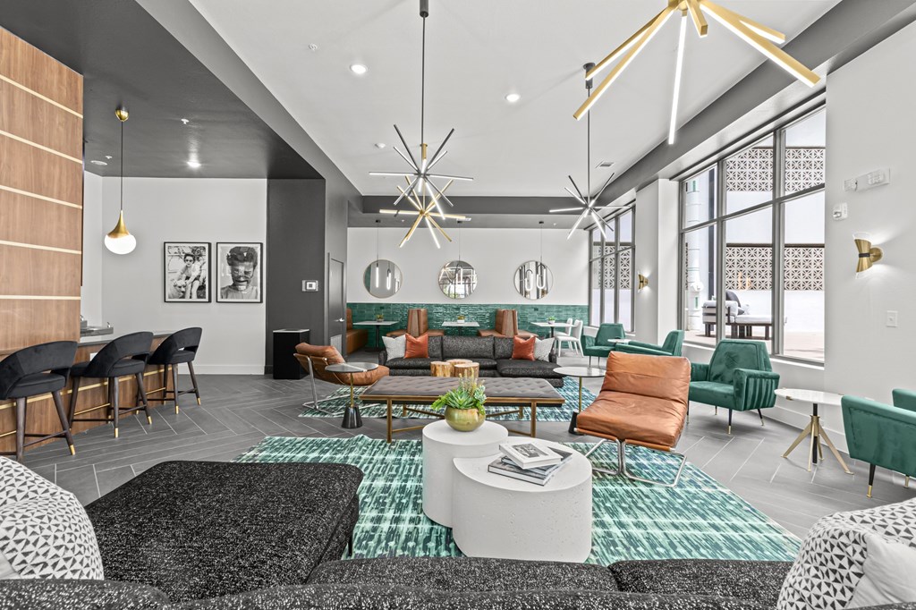 A modern living room with a variety of seating options and a large window.