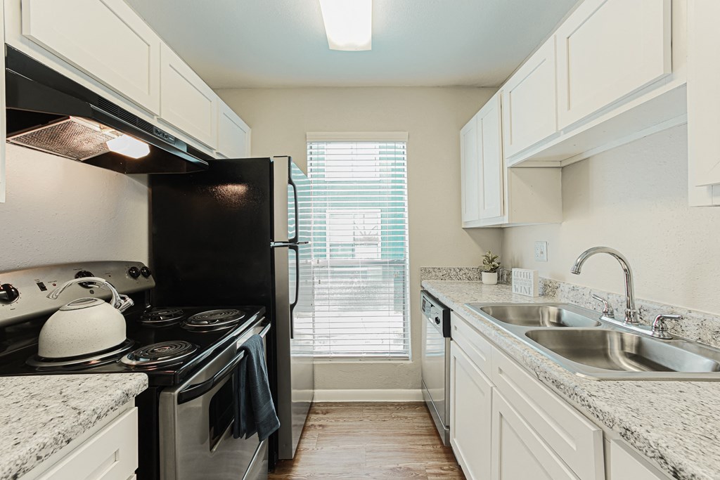 Kitchen With White Cabinetry And Black Appliances  at Cashel Springs, Houston, TX