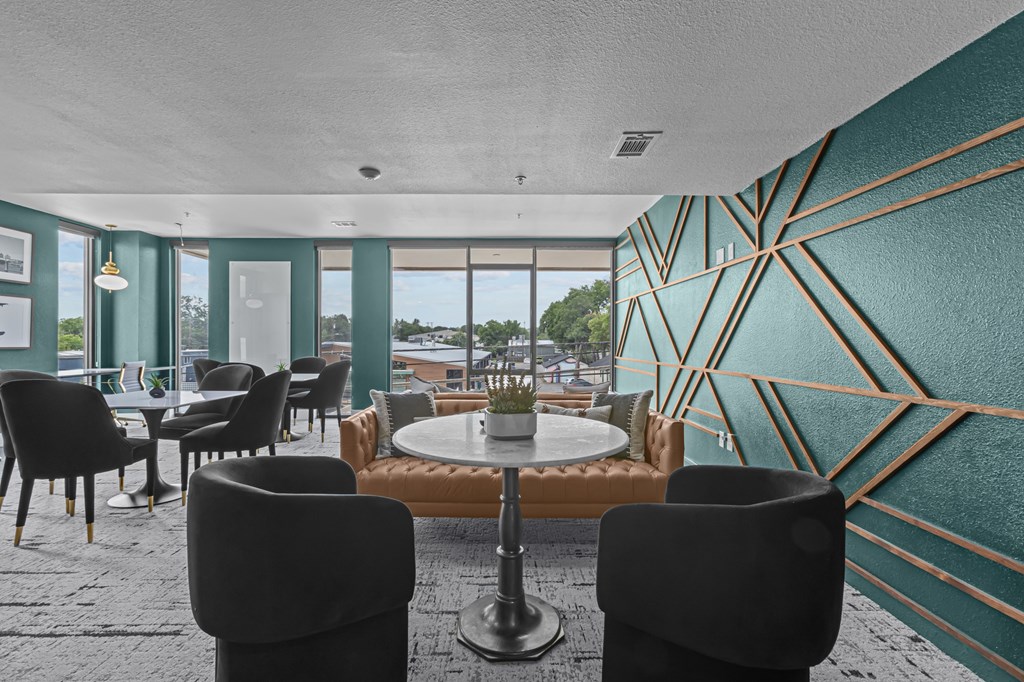 A room with a table surrounded by chairs.