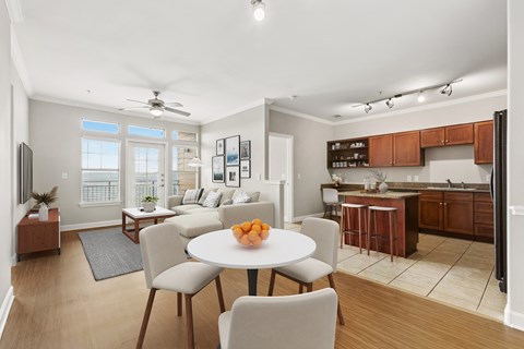 A modern kitchen with a dining table set for four.