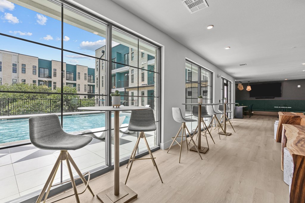 A modern dining room with a pool table and chairs.