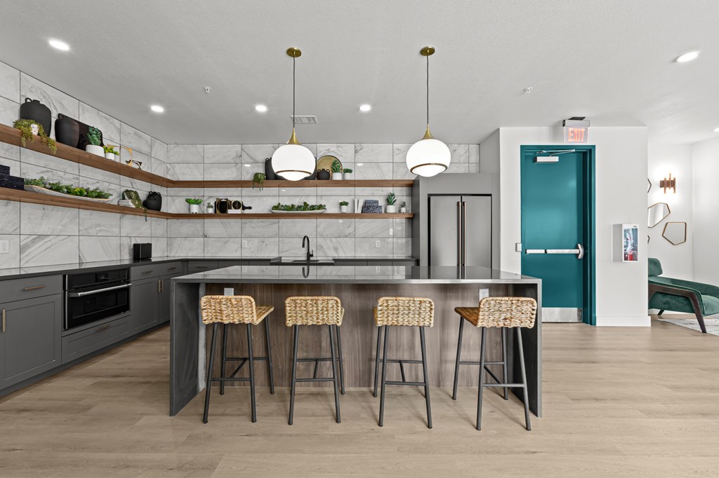 A kitchen with a bar area and stools.