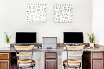 a desk with two computer monitors on top of it