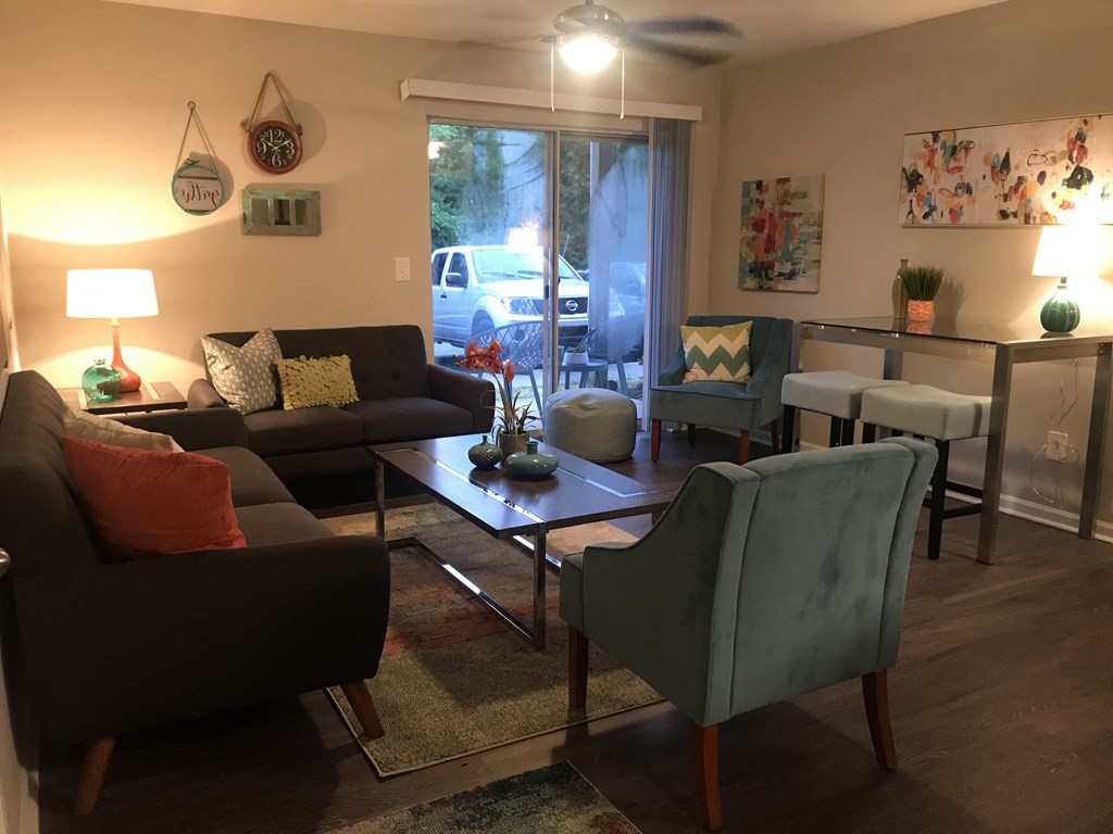 a living room with couches chairs and a coffee table