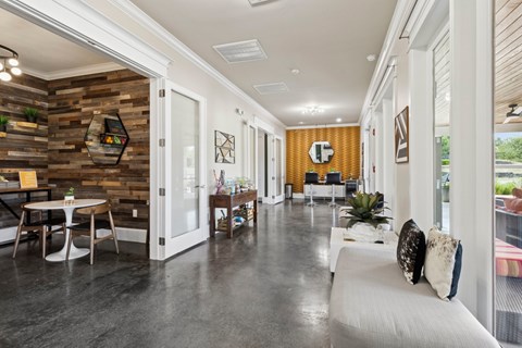 A modern living room with a white couch and a wooden wall.