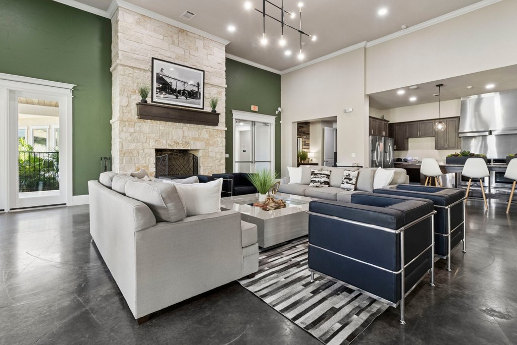 A modern living room with a fireplace and a large couch.