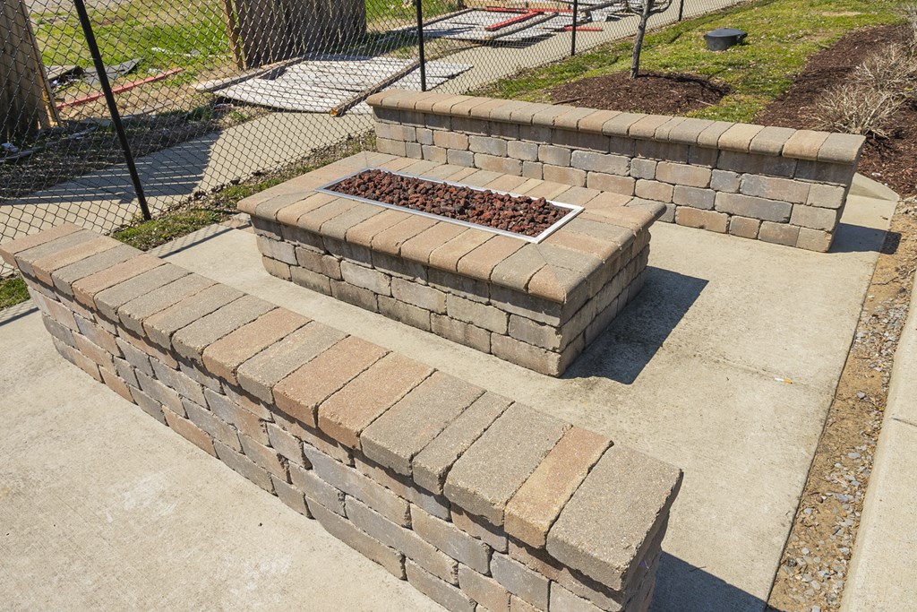 a retaining wall with a fire pit in the middle of it