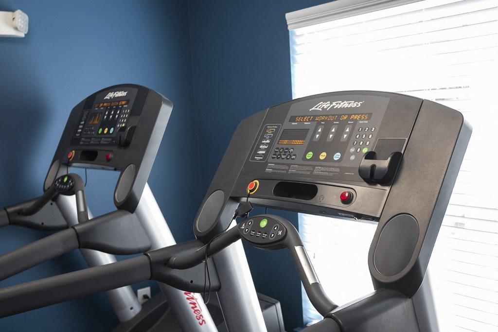 a close up of two treadmills in a gym