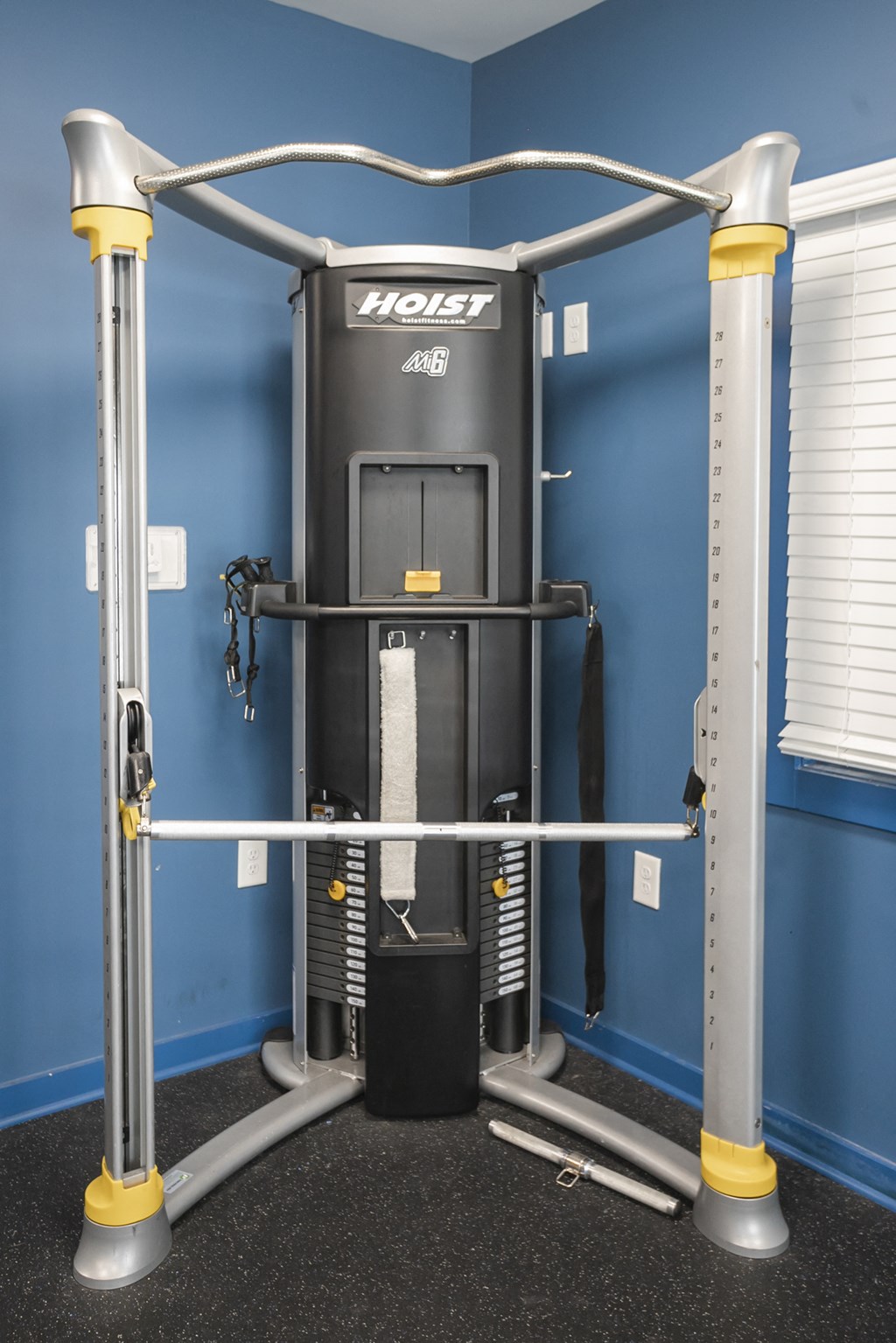 a home gym with a machine in the corner of a room