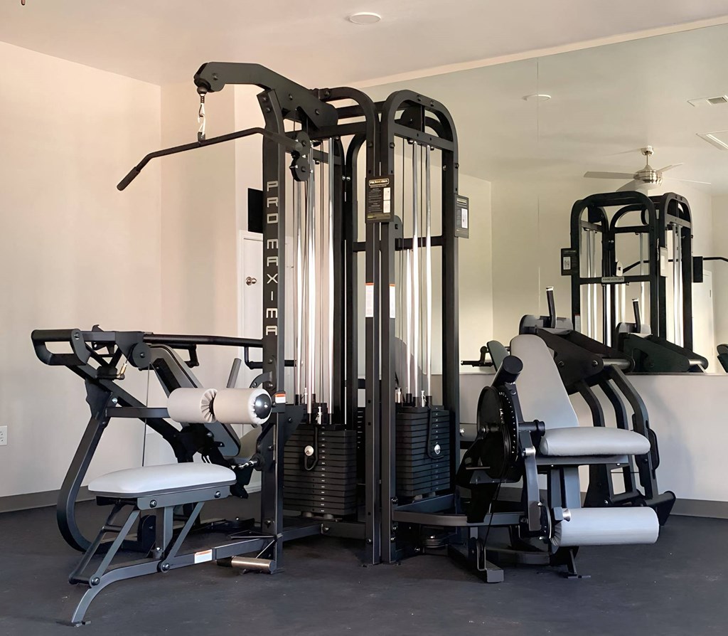 a gym with various machines and weights in it