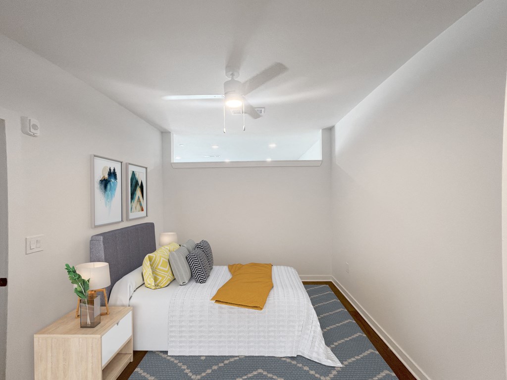 a bedroom with a bed and a ceiling fan