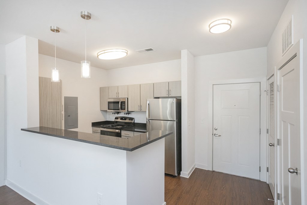 a kitchen with an island and stainless steel appliances