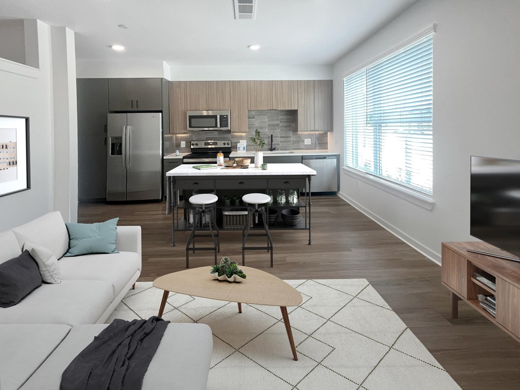 a living room with a kitchen in the background