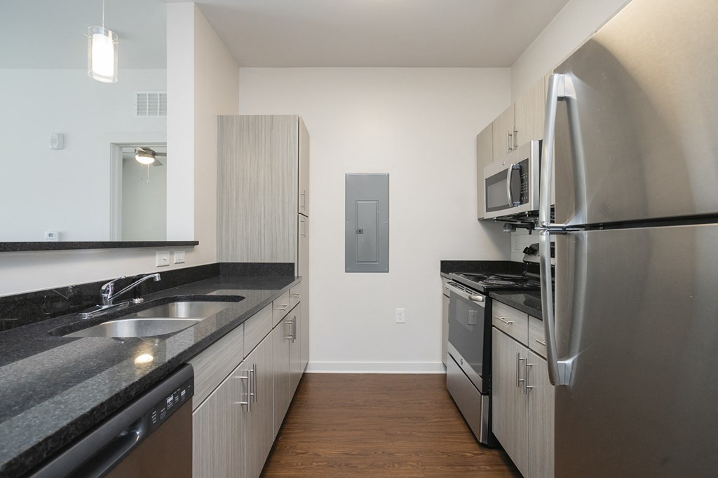 a kitchen with granite countertops and stainless steel appliances