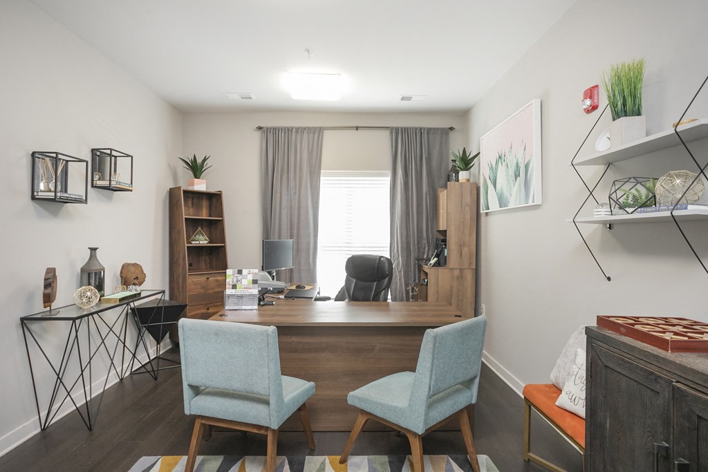 a dining area with a large wooden table and three blue chairs