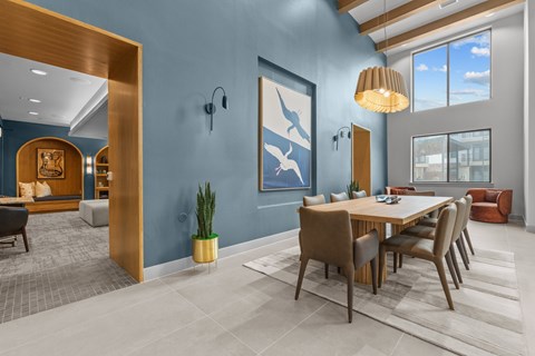 A modern dining room with a wooden table and chairs.