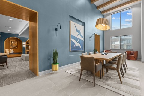 A modern dining room with a wooden table and chairs.