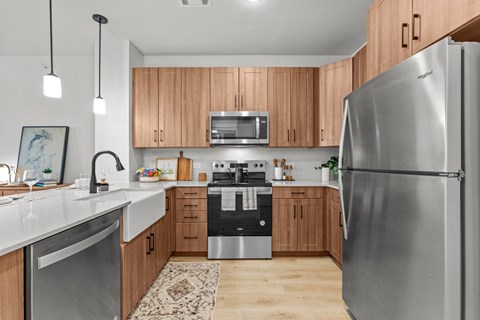 A modern kitchen with wooden cabinets and stainless steel appliances.