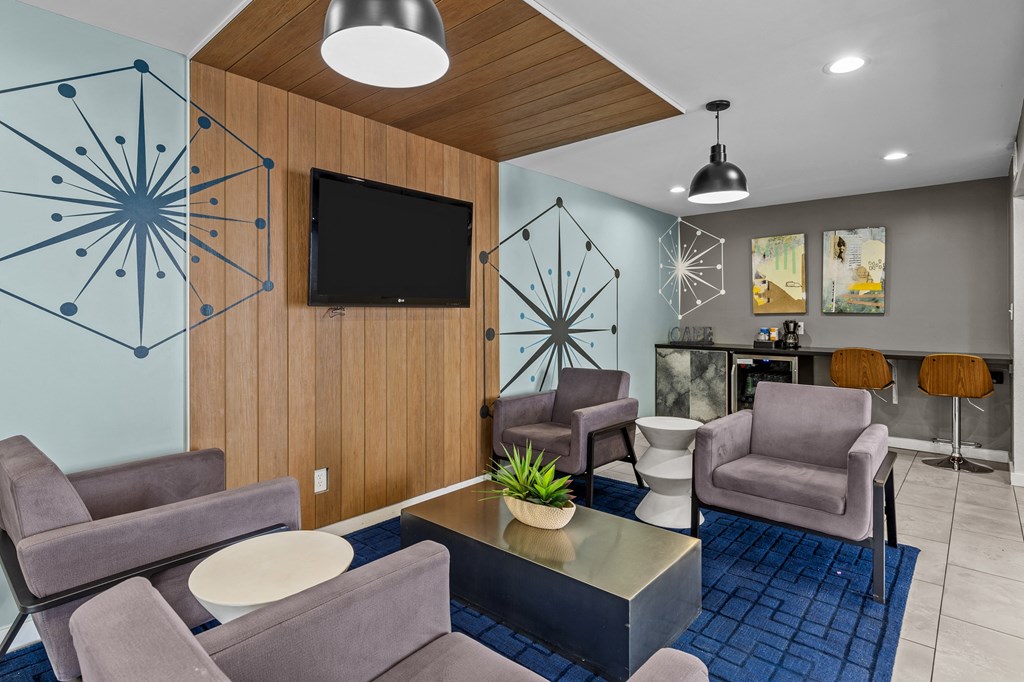 a living room filled with furniture and a flat screen tv