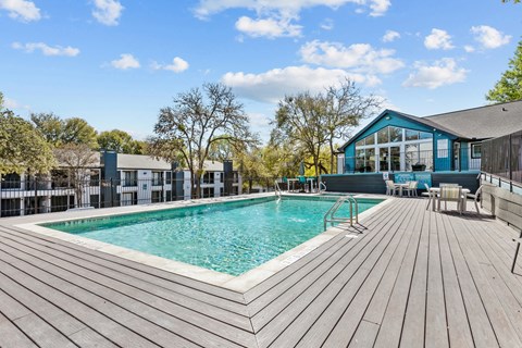 a swimming pool with a house in the background