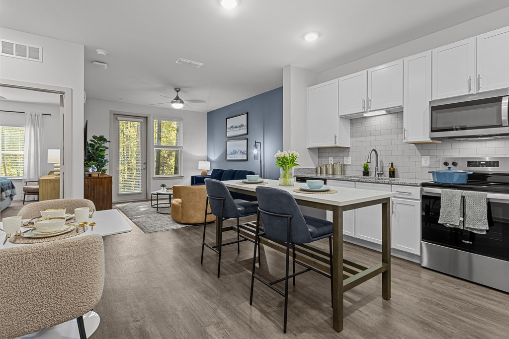 A modern kitchen with a dining area.