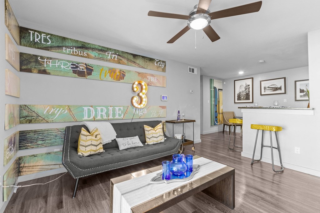 a living room with a couch and a ceiling fan