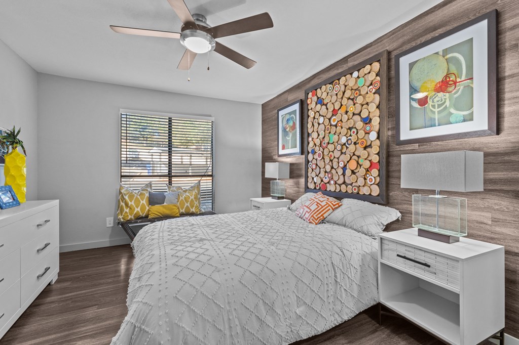 a bedroom with a bed and a ceiling fan
