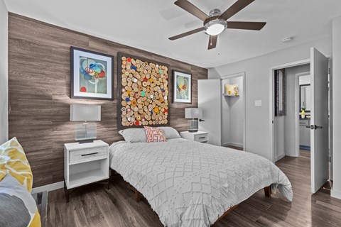 a bedroom with a bed and a ceiling fan