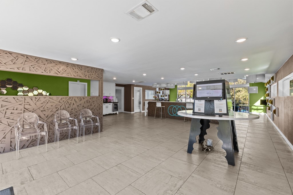 the lobby of a restaurant with a table and chairs