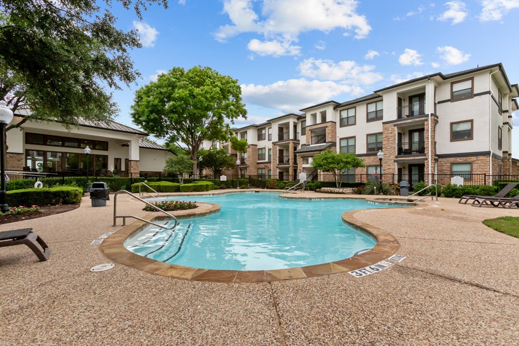 A swimming pool surrounded by apartment buildings.